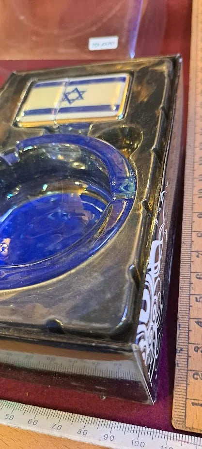 Vintage blue glass ashtray with Israeli flag design, collectible antique item on display