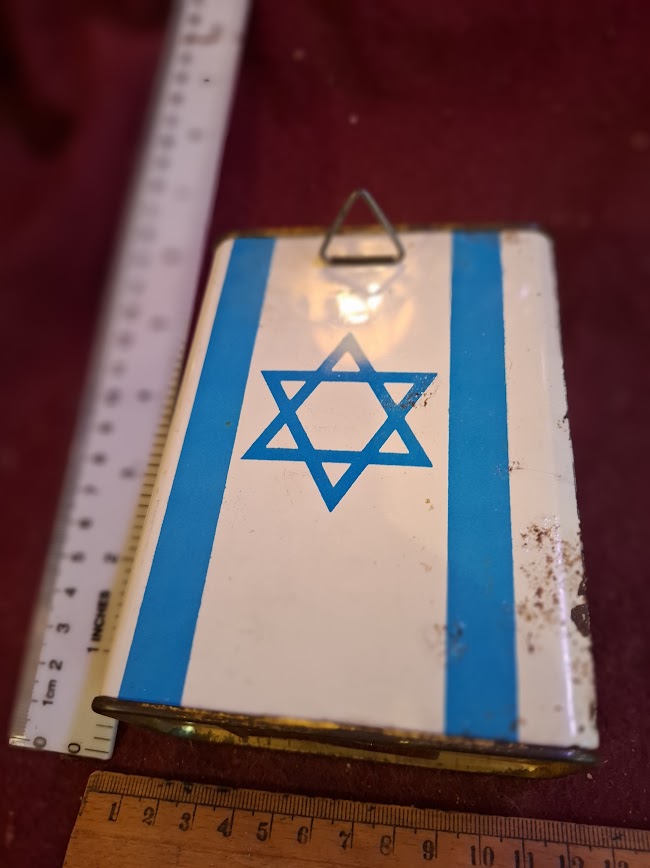 Vintage tin box with blue Star of David and stripes, rulers for scale, collectible item