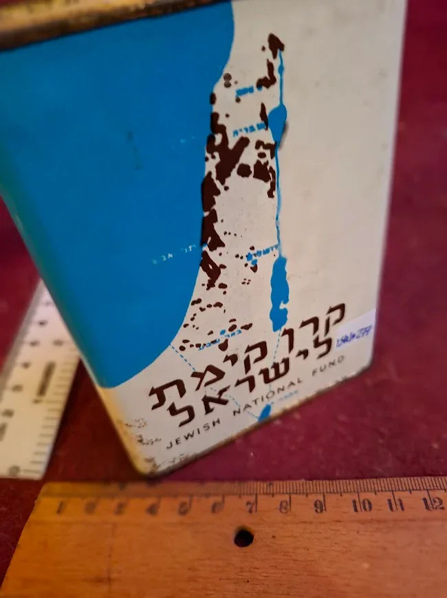 Vintage Jewish National Fund tin box featuring Israel map, with rulers on red surface