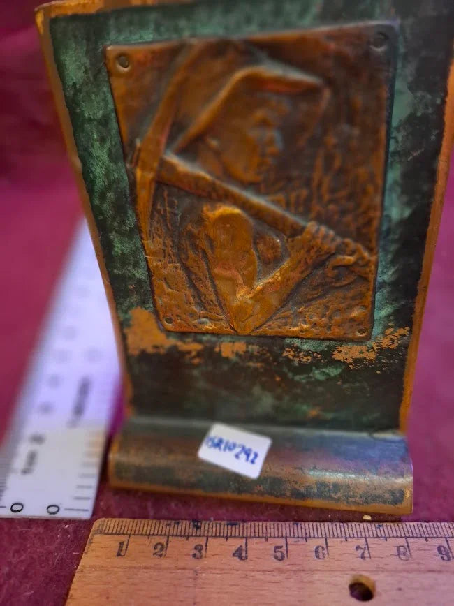Vintage brass bookend with embossed miner design, patina finish, rulers for scale