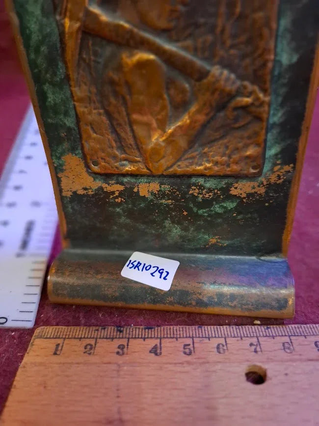 Close-up of antique bronze decorative item with patina, rulers for scale, and label 15R10292.