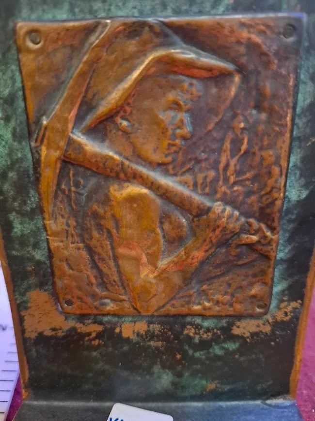 Vintage embossed copper plaque of miner with pickaxe, antique collectible decor